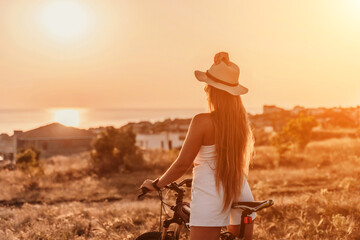 Woman travel bike. Happy woman cyclist sitting on her bike, enjoying the beautiful mountain and sea...