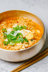 Korean instant spicy ramen dish in white bowl on table