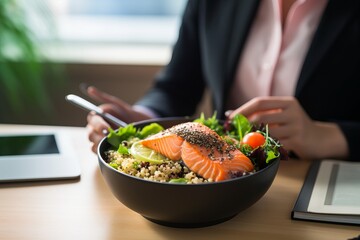 female office worker in white shirt eating for lunch Trendy dish poke bowl with rice or quinoa and...