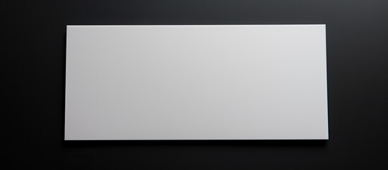 Obraz premium business card with white color and copy space on a black background. It is related to business, business cards, stationery, and writing space.