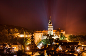 Fototapeta na wymiar Night Shot of Beautiful Cesky Krumlov in the Czech Republic, with the Tower of St Jost Church and the Castle Dominating the City