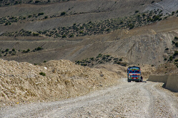 A truck in the middle of an offroad in a desert in Ghiling Village of Upper Mustang, Nepal