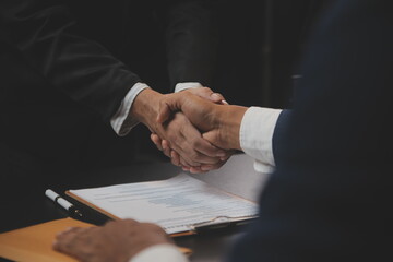 .Business and lawyers discussing contract papers with brass scale on desk in office. Law, legal services, advice, justice and law concept picture with film grain effect