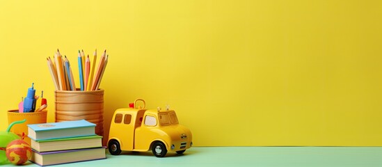 The photo shows a yellow background with educational wooden kid toys and a blank spiral sketchbook notebook on top. represents early education, kindergarten, preschool, and learning and playing.