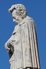 Fototapeta premium Statue of Giacomo Leopardi in the main square in the town of Recanati in the Marche region of Italy. He was one of Italy's most important poets.