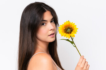 Young Brazilian woman isolated on white background holding a sunflower. Close up portrait