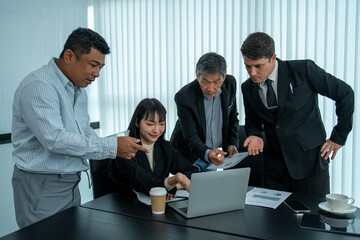 Business man and woman working together weekly analysis on laptop on tablet and blueprint in office.