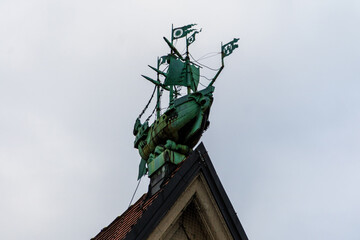 Fototapeta na wymiar Copper clipper ship model on top of building