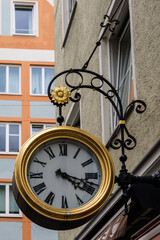 Fototapeta na wymiar Clock with Roman numerals on building