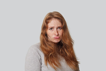 Funny sad woman with long hair on white background