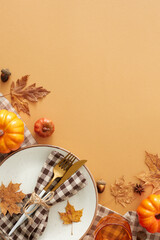 Fall-themed table setup idea. Top view vertical shot of plate, cutlery, checkered napkin,...