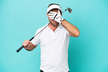 Middle age caucasian golfer player man isolated on blue background covering eyes by hands. Do not...