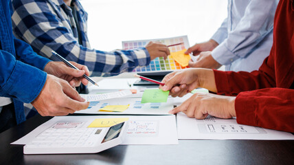Close-up ux developers and ui designers use augmented reality to brainstorm on mobile app interface...