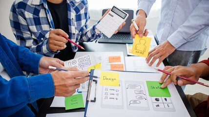 Close-up ux developers and ui designers use augmented reality to brainstorm on mobile app interface...