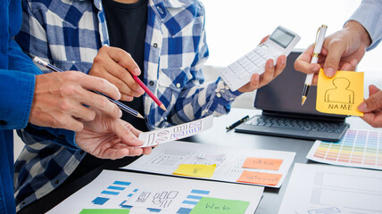 Close-up ux developers and ui designers use augmented reality to brainstorm on mobile app interface...