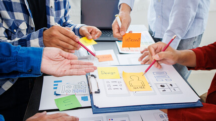 Close-up ux developers and ui designers use augmented reality to brainstorm on mobile app interface...