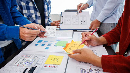 Close-up ux developers and ui designers use augmented reality to brainstorm on mobile app interface...