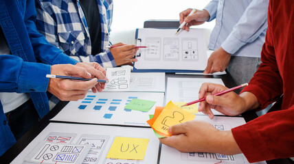 Close-up ux developers and ui designers use augmented reality to brainstorm on mobile app interface...