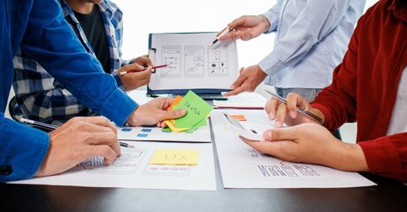 Close-up ux developers and ui designers use augmented reality to brainstorm on mobile app interface...