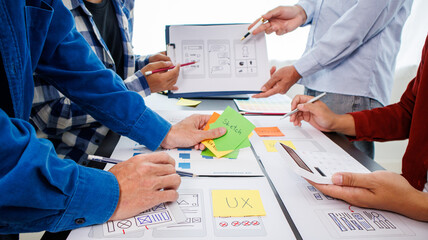 Close-up ux developers and ui designers use augmented reality to brainstorm on mobile app interface...