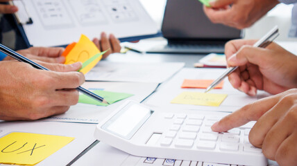 Close-up ux developers and ui designers use augmented reality to brainstorm on mobile app interface...
