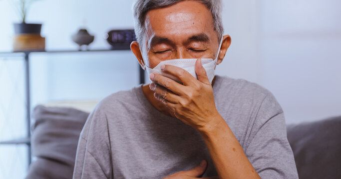 An Elderly Asian Man Wearing A Mask While Having A Respiratory Illness.