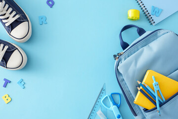 Back-to-school atmosphere theme. Top view shot of trendy gumshoes, child's rucksack, educational tools, blue letters on pastel blue background with empty space for advert or text