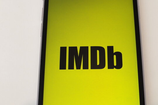 Brand of IMDB. On a mobile phone. Close up and isolated on a white background.