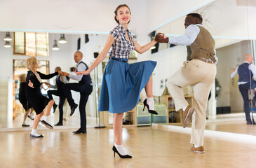 Woman with african man practising charleston dancing