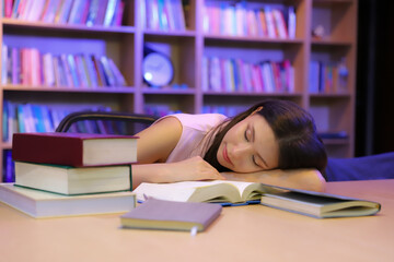 Tired student woman sleeping on table at night home, education, freelance, overwork and people concept