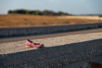 a girl's shoe on the road