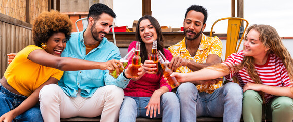 Multiethnic group of friends having dinner barbecue party on rooftop at home