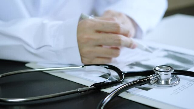 professional doctor wearing uniform taking notes in journal, physician therapist practitioner filling medical documents on clipboard patient form history and prescription, talking with patient.