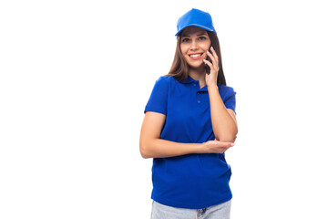 merch design concept. smiling young woman in blue cotton t-shirt and cap talking on the phone