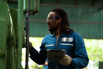Male worker working with industrial machinery in factory. Stress from work. Tired of repetitive work.