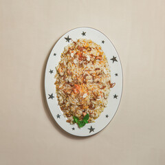 A traditional rice dish Pilaf or pilau is homemade and decorated with chicken roast..