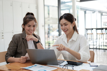 Young motivated business team working together in the office room, preparing for their meeting.