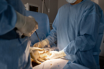 Two surgeons operates abdominal area of a patient. Concept of real operation and surgical...