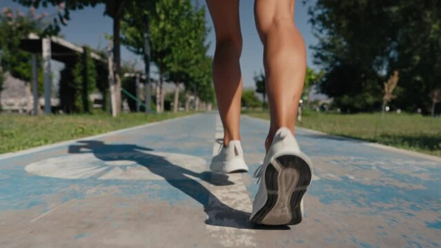 woman runner athlete legs jogging exercising running fitness lifestyle in early morning urban city slow motion. High quality 4k footage