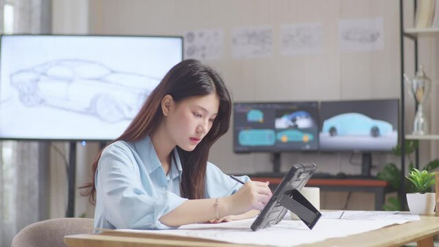 Side View Of Asian Female Yawning While Drawing New Car Design Concept On A Tablet In The Studio With Tv And Computers Display 3D Electric Car Model 
