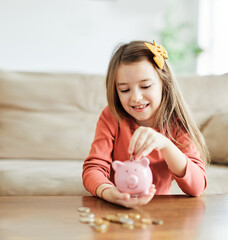 child saving money girl bank finance investment coin happy save wealth young piggy cash kid little economy financial childhood banking pig piggybank home family cute future currency