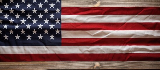 Independence Day for Americans is celebrated on the 4th of July. The American flag is displayed on a red, old, rustic wooden background with space for adding text. It can be used as a background