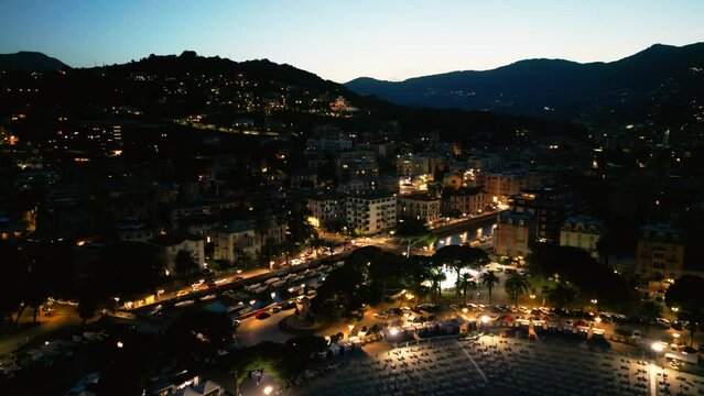 night city lights, city ​​of italy in the light of lanterns, warm light, yachts on the canal, ships in the pier, nightlife, Italy Rapallo