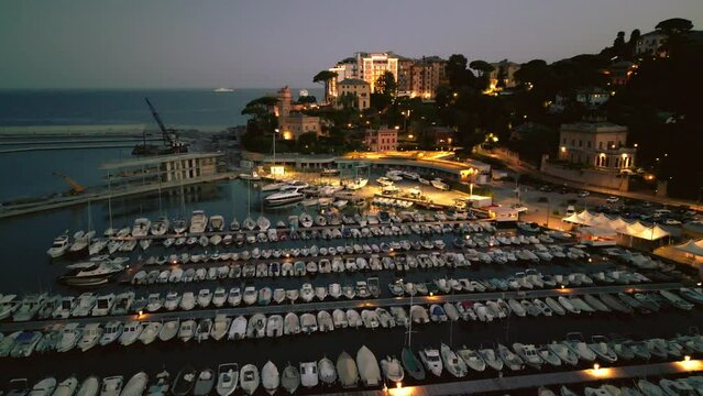 night city lights, city ​​of italy in the light of lanterns, warm light, yachts on the canal, ships in the pier, nightlife, Italy Rapallo
