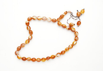 A picture of tasbeeh or prayer beads with copyspace white background.