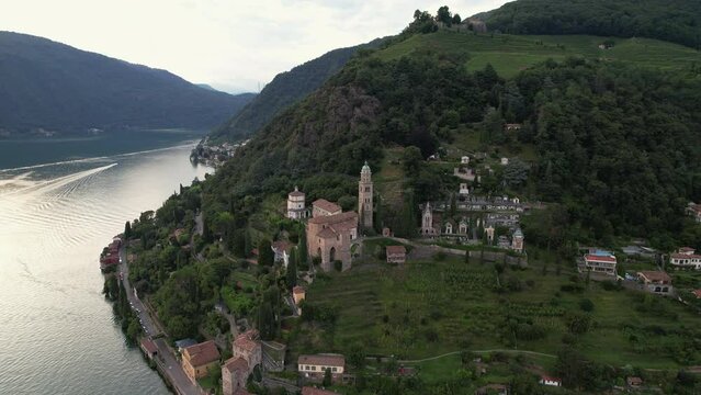 Aerial footage of the parish church Madonna del Sasso stands on the high hill of Vico Morcote. Morcote at the Lake Lugano was once credited as one of the most beautiful Swiss villages
