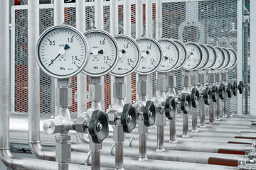 Stainless steel installation. Group of manometers instaled on pipeline in petrochemical technology