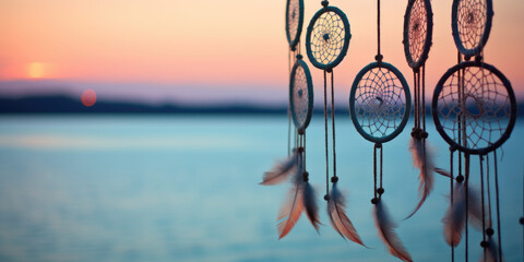 Handmade dream catcher with feathers threads and beads rope hanging on the beach