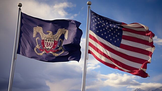 The Utah state flag waving along with the national flag of the United States of America.