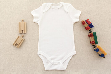 Baby white bodysuit  mock-up for your design with toys. White blank onesie with space for your design.